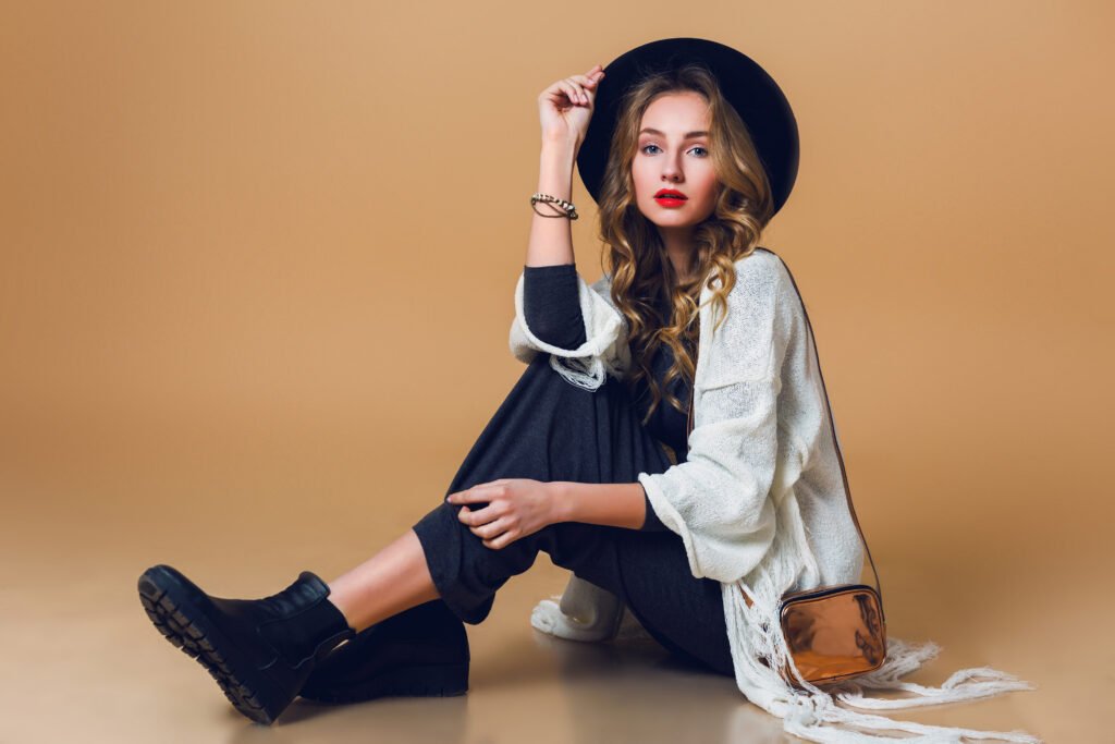 high fashion portrait young elegant blonde woman black wool hat wearing oversize white fringe poncho with long grey dress